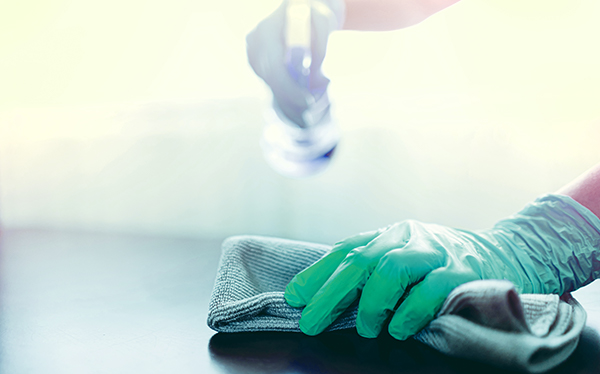 Sanitizing a surface with a spray bottle and clean cloth